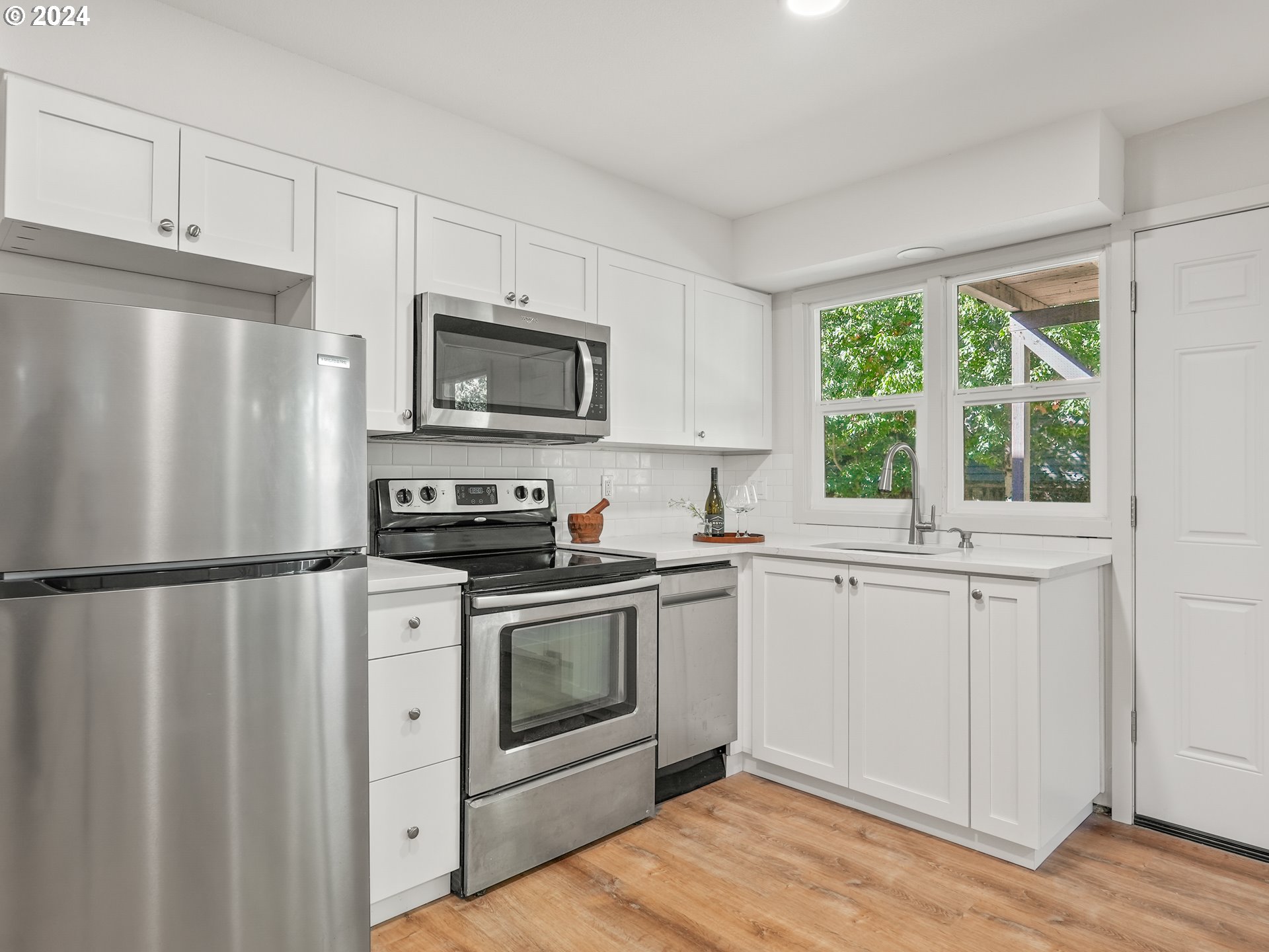 5525 Southwest Florida Street Portland, OR 97219 - Photo 30 of 44 a kitchen with appliances a sink and a window