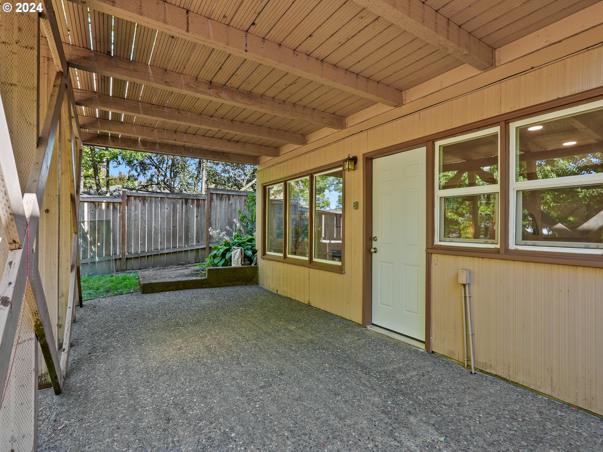 5525 Southwest Florida Street Portland, OR 97219 - Photo 41 of 44 a view of a porch with furniture and floor to ceiling window