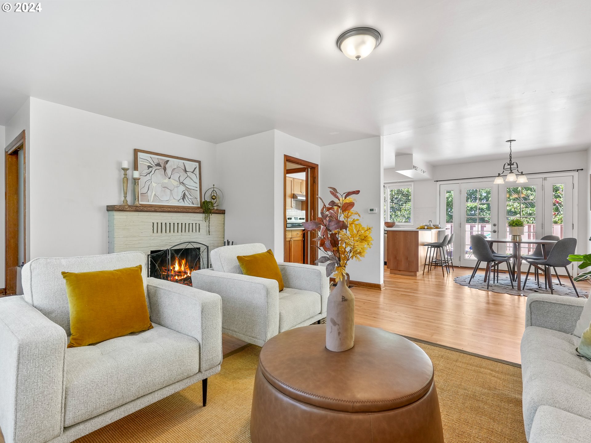 5525 Southwest Florida Street Portland, OR 97219 - Photo 6 of 44 a living room with fireplace furniture and a large window