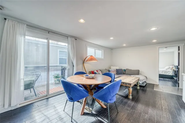 a dining room with furniture wooden floor and a chandelier
