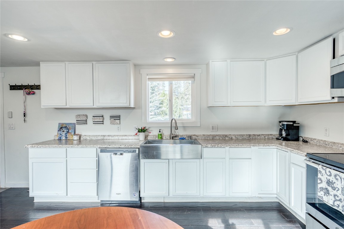 847 Airport Road, Unit 14 Breckenridge, CO 80424 - Photo 15 of 27 a kitchen with granite countertop white cabinets and white appliances
