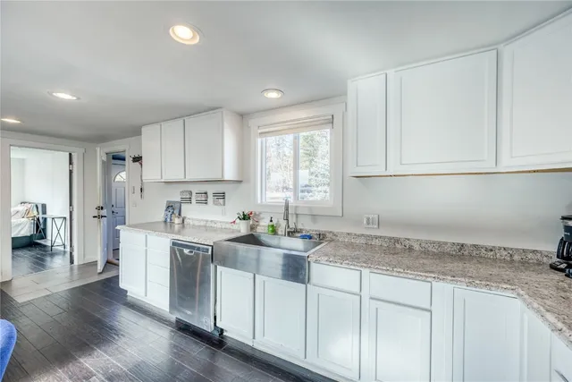 a kitchen with a sink a window and cabinets