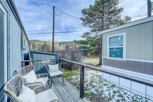 a view of a chair and tables in the balcony