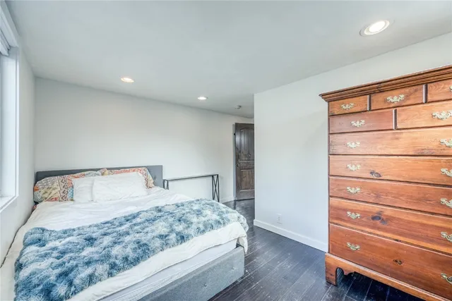 a bedroom with a bed and a dresser