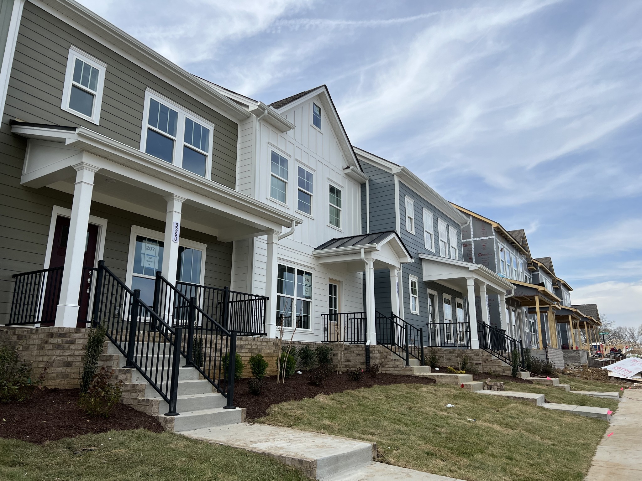 a front view of a residential apartment building with a yard