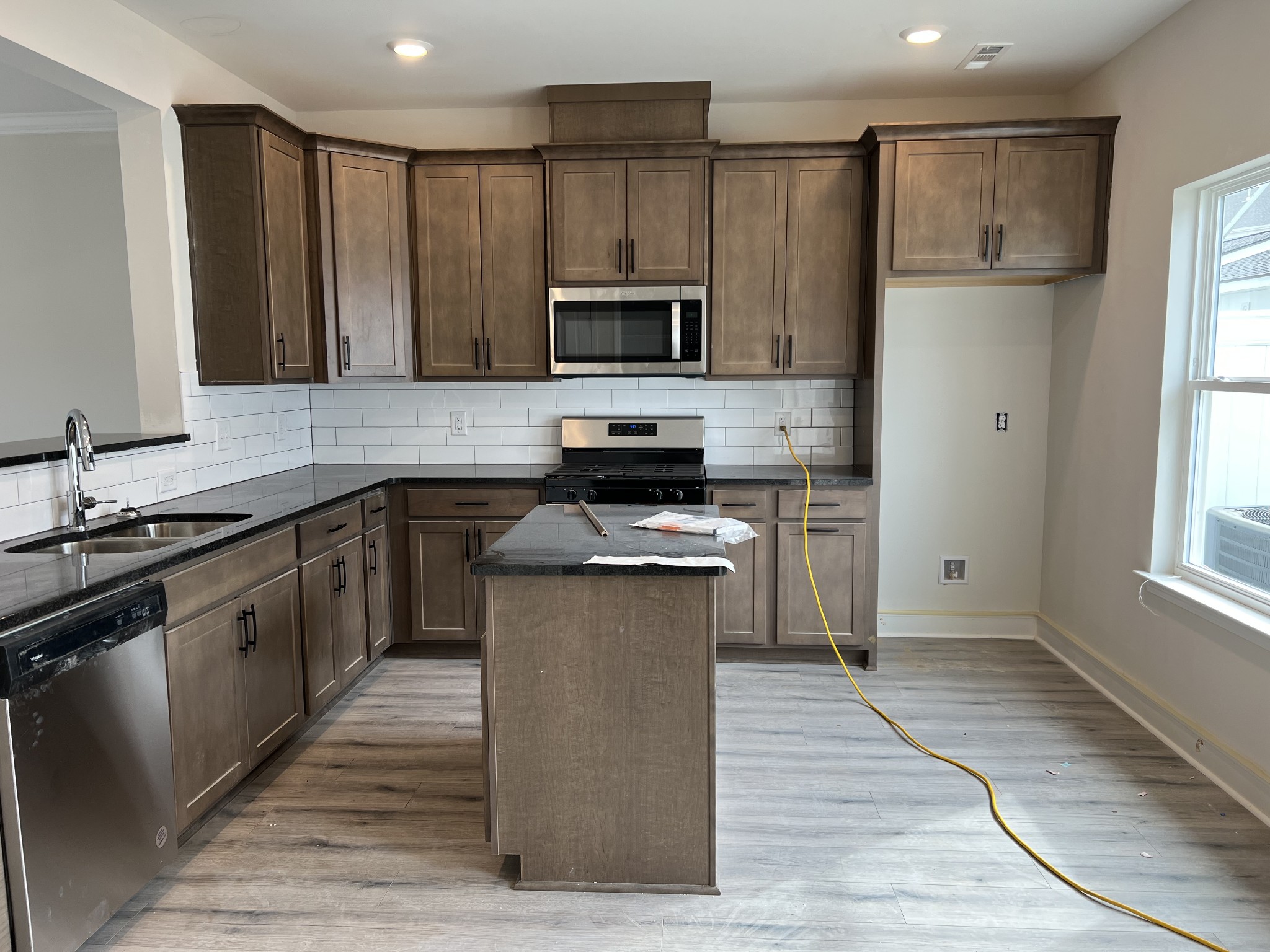 3258 Tasker Drive Antioch, TN 37013 - Photo 4 of 26 a kitchen with kitchen island granite countertop a sink cabinets and stainless steel appliances