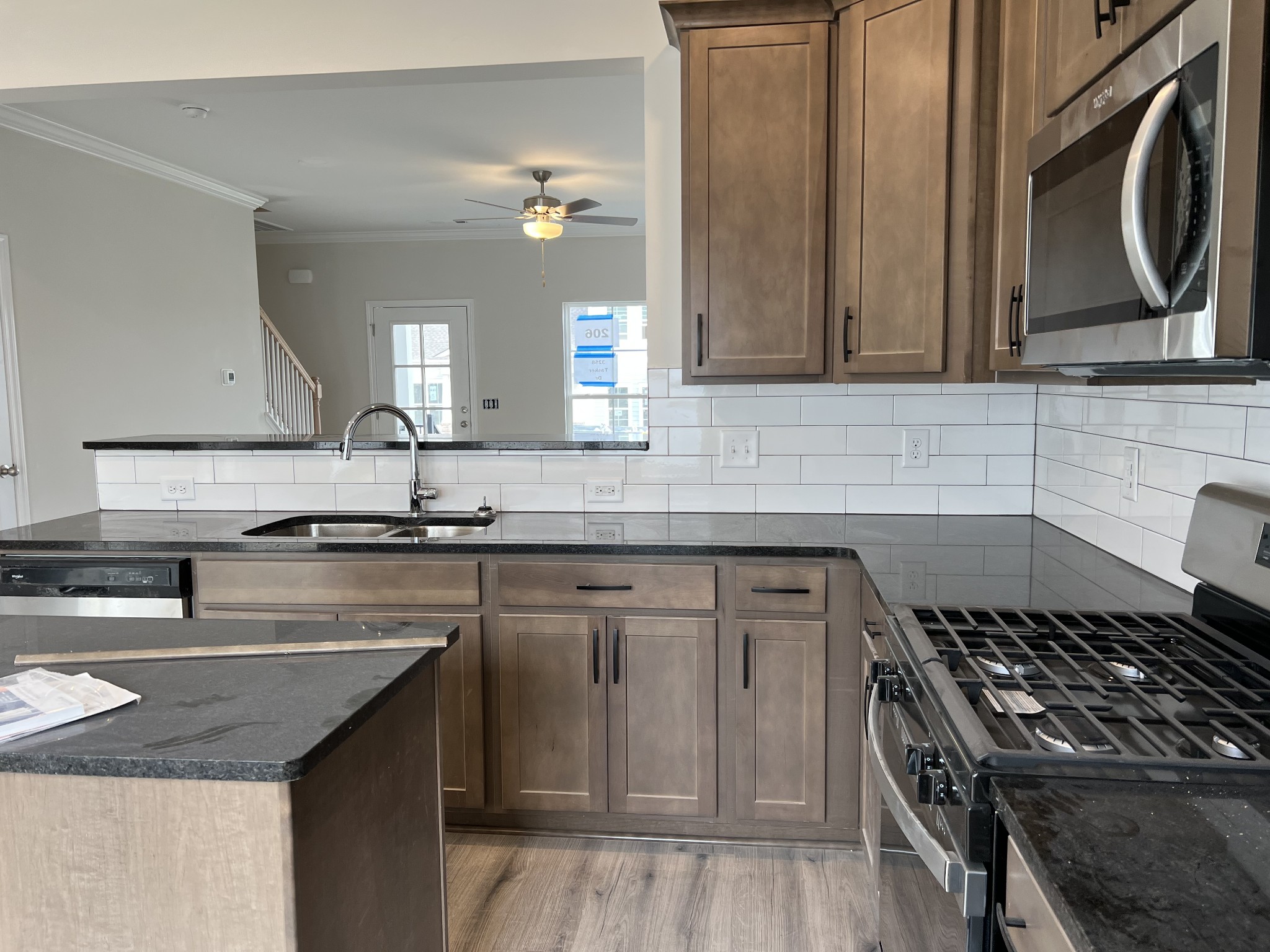 3258 Tasker Drive Antioch, TN 37013 - Photo 5 of 26 a kitchen with granite countertop a sink stove and cabinets