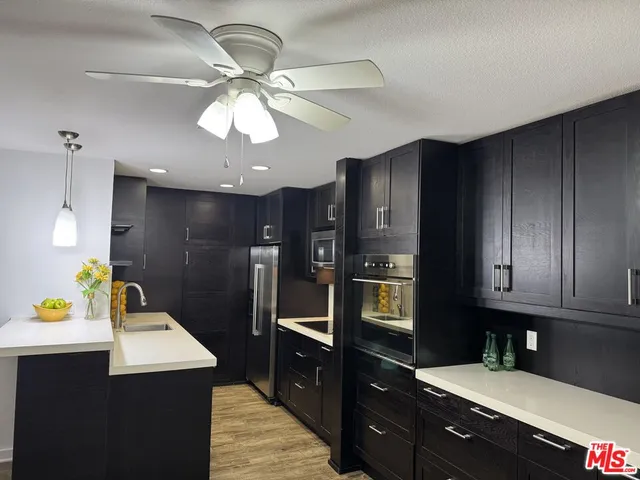 a kitchen with a refrigerator and a sink