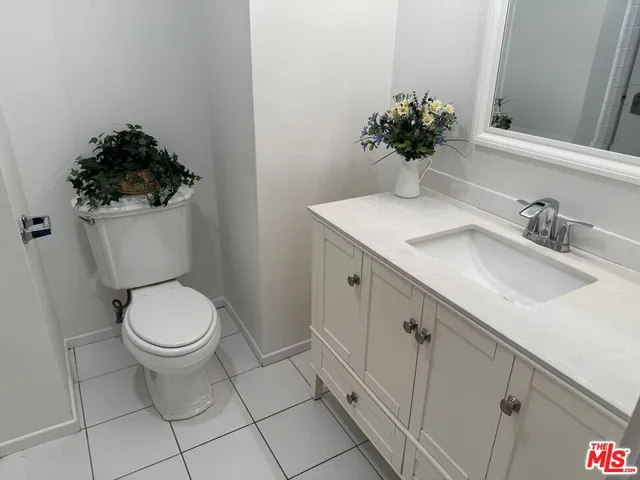 a bathroom with a shower sink and mirror
