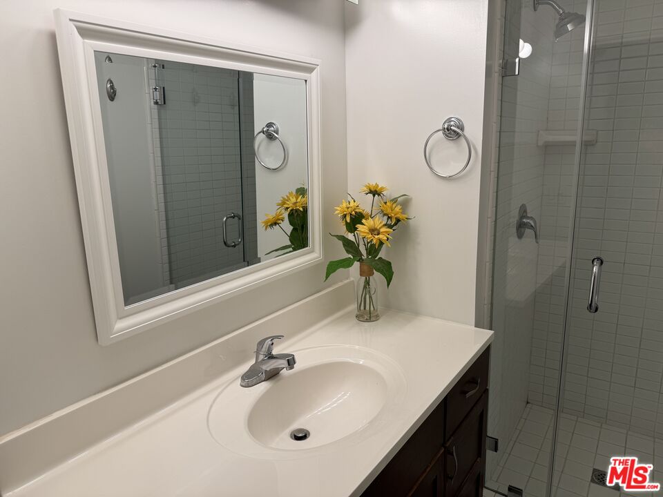 8640 Gulana Avenue, Unit K1020 Playa del Rey, CA 90293 - Photo 15 of 35 a bathroom with a shower sink and mirror