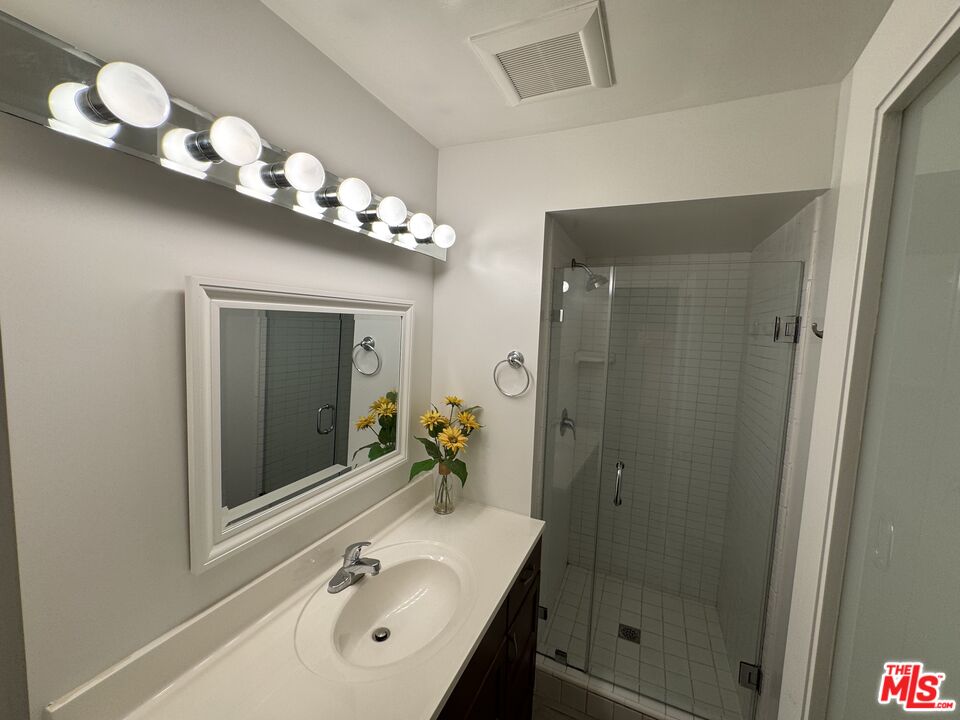 8640 Gulana Avenue, Unit K1020 Playa del Rey, CA 90293 - Photo 16 of 35 a bathroom with a sink vanity and a mirror