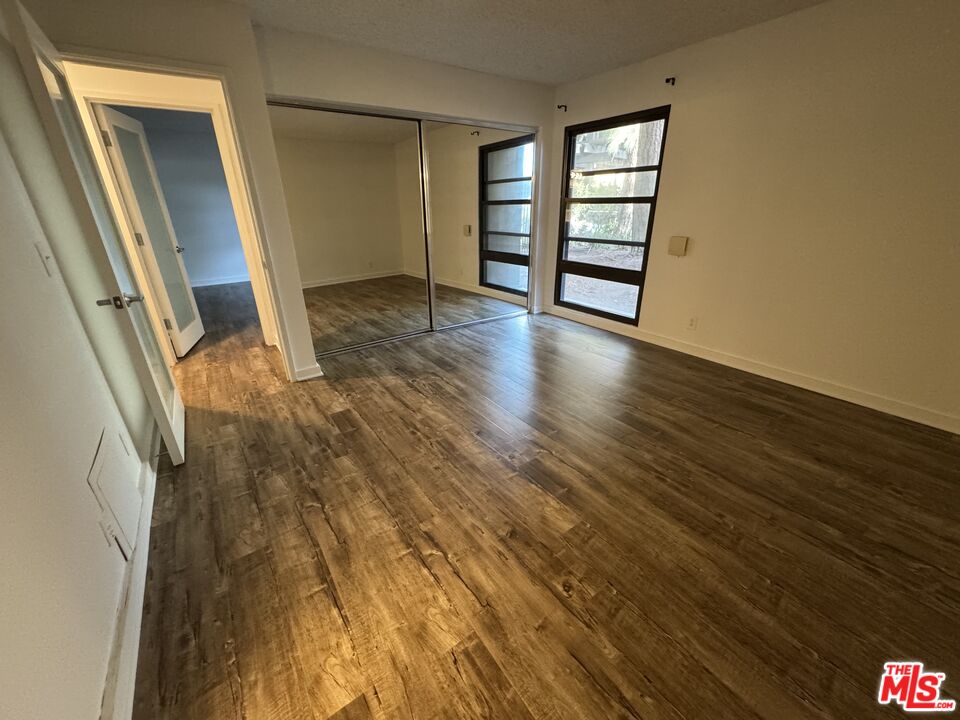 8640 Gulana Avenue, Unit K1020 Playa del Rey, CA 90293 - Photo 17 of 35 an empty room with wooden floor and entrance
