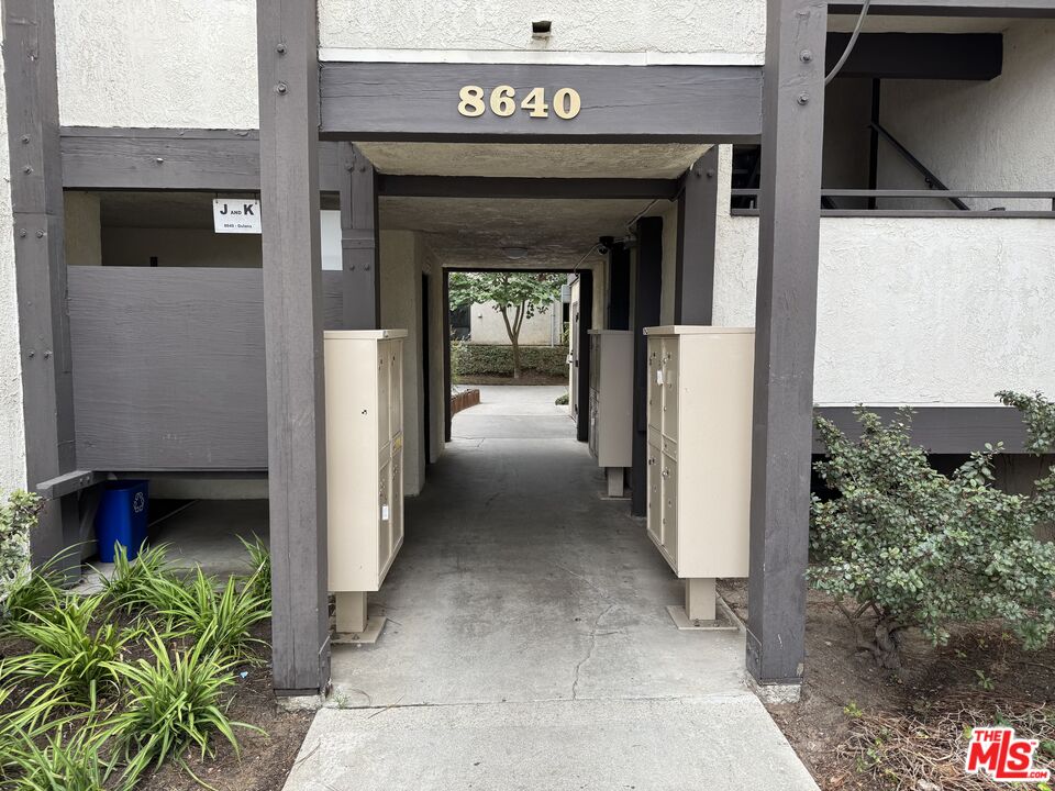 8640 Gulana Avenue, Unit K1020 Playa del Rey, CA 90293 - Photo 18 of 35 a view of a hallway with a door and a car parked