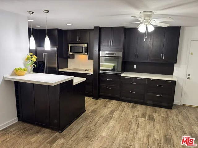 a kitchen with a stove a refrigerator and a sink