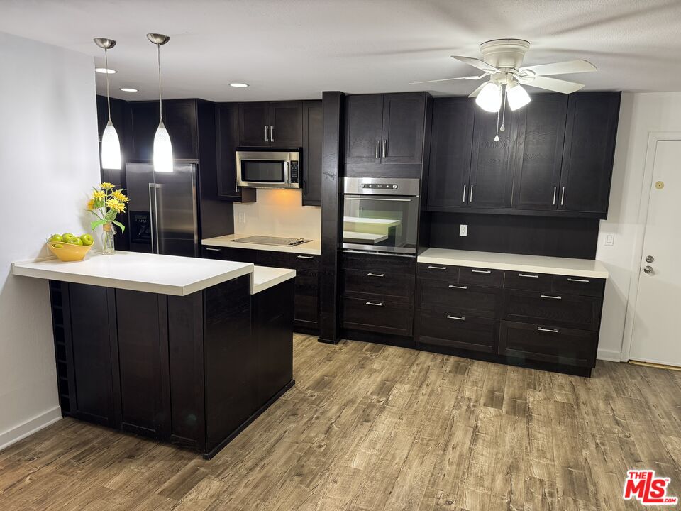 8640 Gulana Avenue, Unit K1020 Playa del Rey, CA 90293 - Photo 3 of 35 a kitchen with a stove a refrigerator and a sink