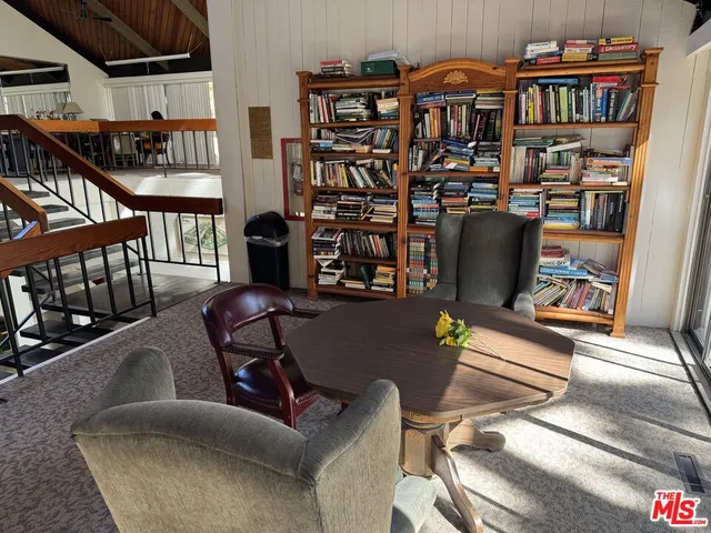 a room with pool table and windows