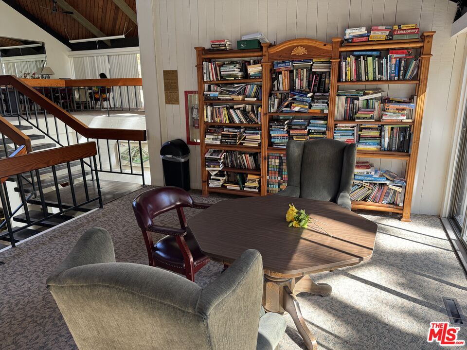 8640 Gulana Avenue, Unit K1020 Playa del Rey, CA 90293 - Photo 32 of 35 a living room with furniture a book shelf and wooden floor