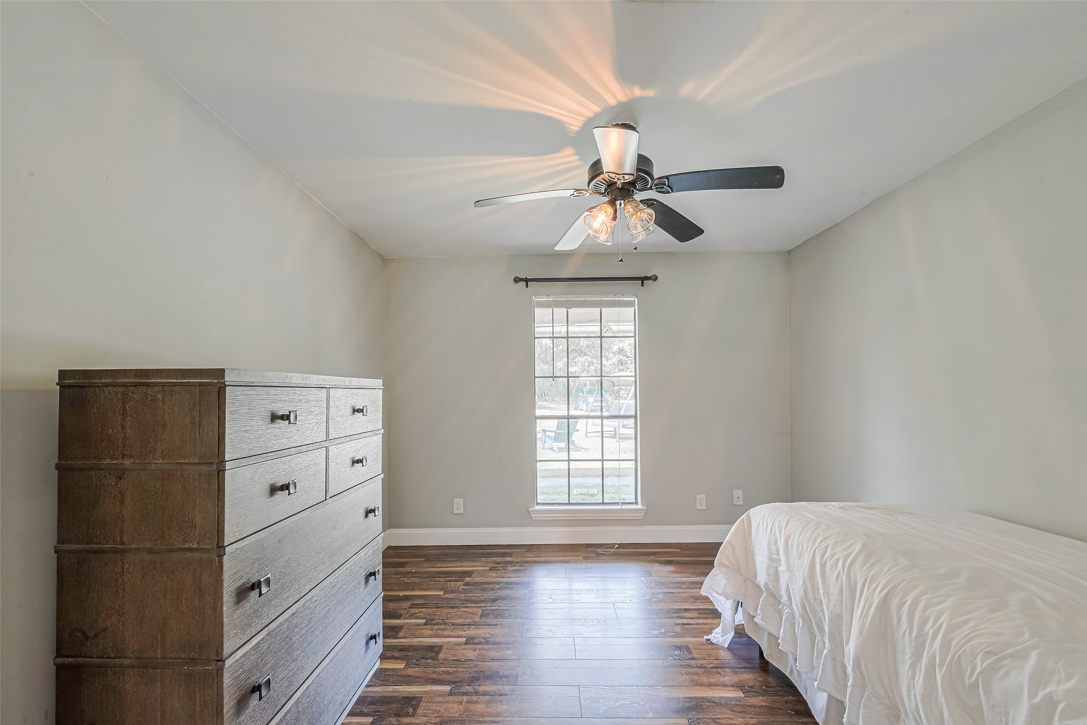 24314 Anderson Street Huffman, TX 77336 - Photo 30 of 48 a bedroom with a bed and a chandelier