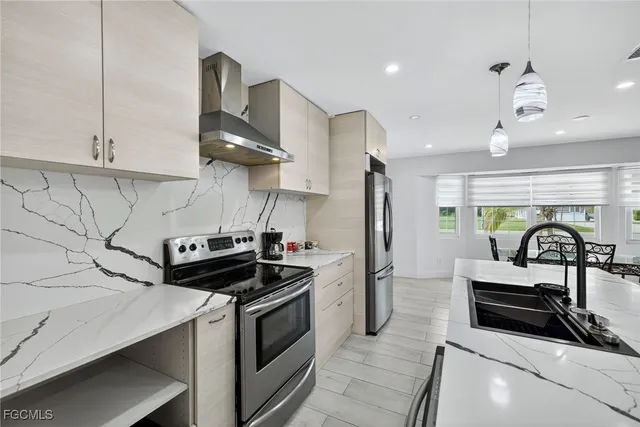 a kitchen with stainless steel appliances a stove a sink and a refrigerator