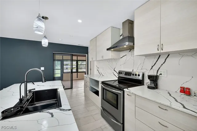 a kitchen with kitchen island a stove and a sink