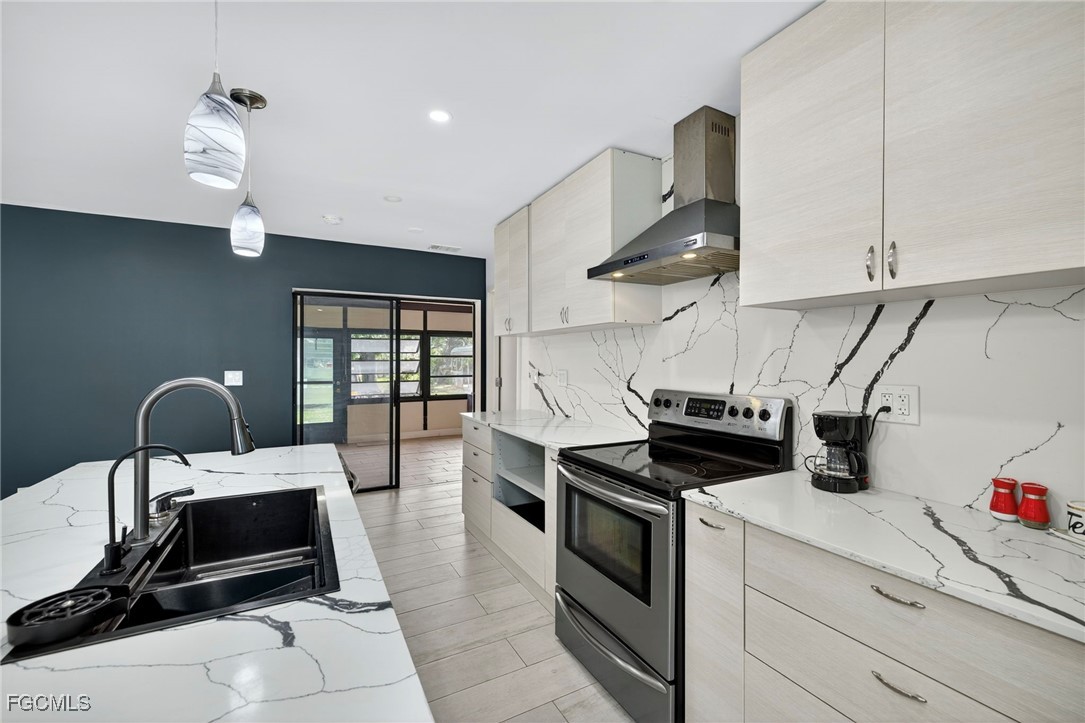 1672 Many Road North Fort Myers, FL 33903 - Photo 12 of 50 a kitchen with kitchen island a stove and a sink