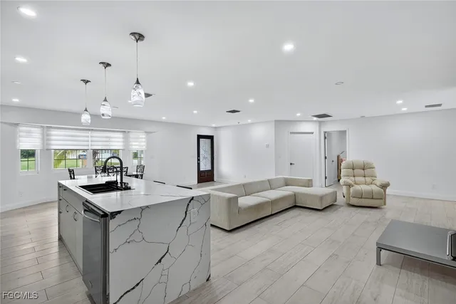 a kitchen with living room and white cabinets
