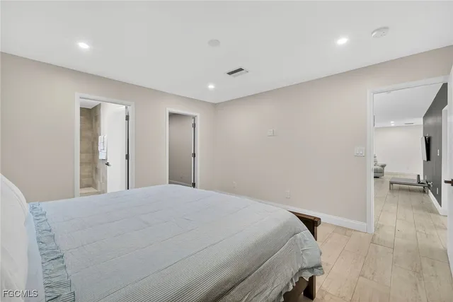 a bedroom with a bed and a view of bathroom