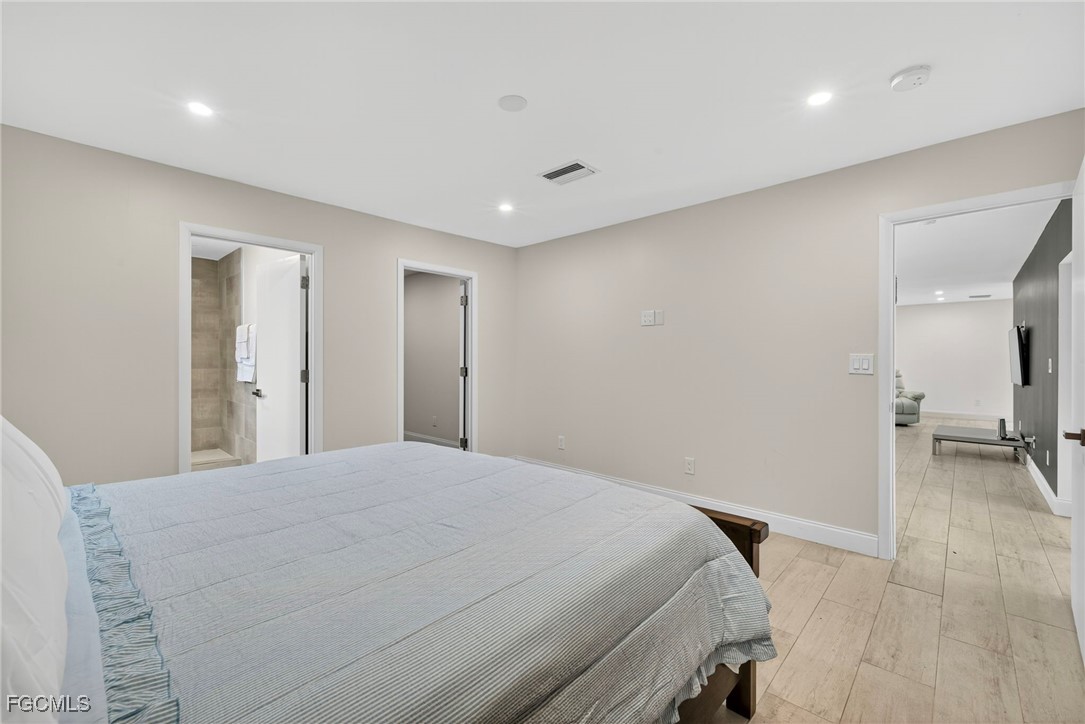 1672 Many Road North Fort Myers, FL 33903 - Photo 17 of 50 a bedroom with a bed and a view of bathroom