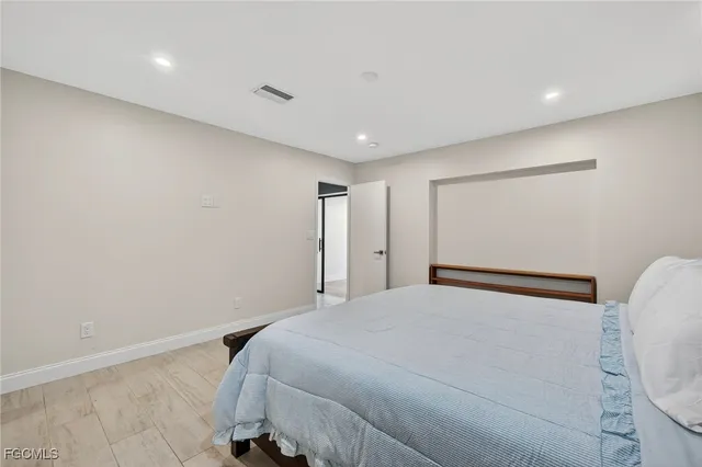 a bedroom with a bed and a mirror