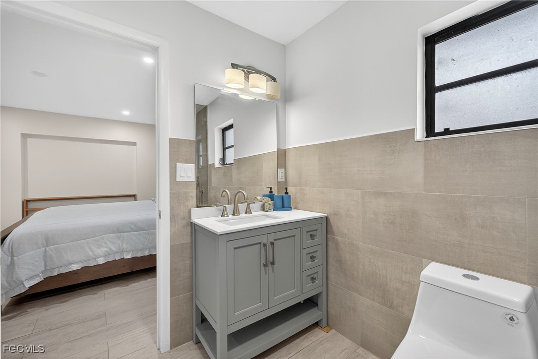 1672 Many Road North Fort Myers, FL 33903 - Photo 20 of 50 a bathroom with a double vanity sink toilet and mirror