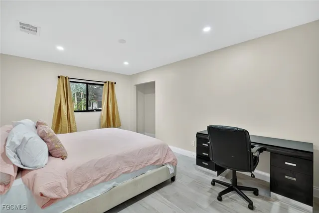 a bedroom with a bed and chair