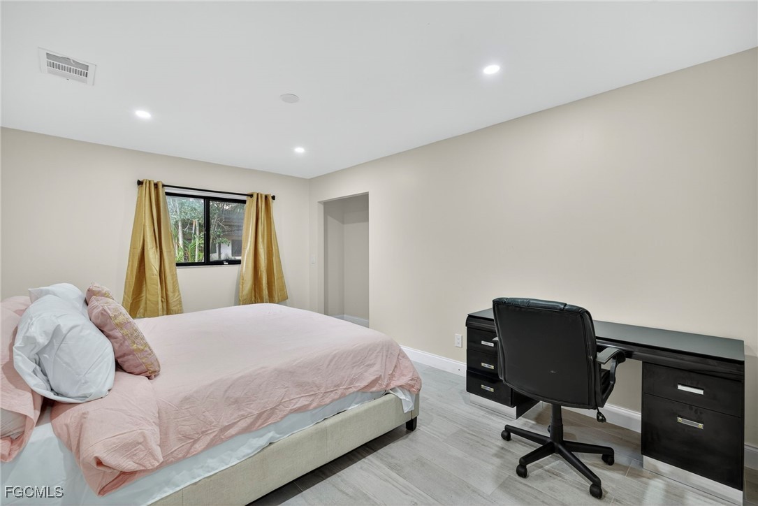1672 Many Road North Fort Myers, FL 33903 - Photo 22 of 50 a bedroom with a bed and chair