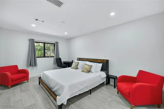 a bedroom with a bed and a couch