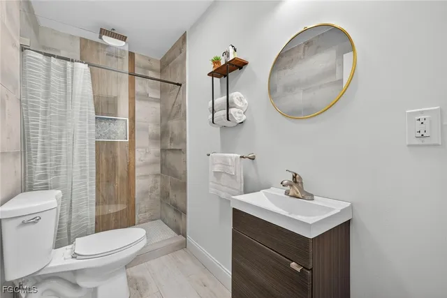 a bathroom with a sink a toilet and a mirror