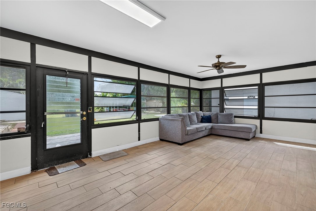 1672 Many Road North Fort Myers, FL 33903 - Photo 26 of 50 a view of an empty room with furniture wooden floor and windows
