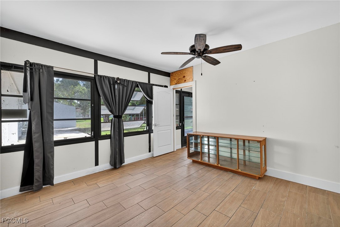 1672 Many Road North Fort Myers, FL 33903 - Photo 29 of 50 wooden floor in an empty room with a window