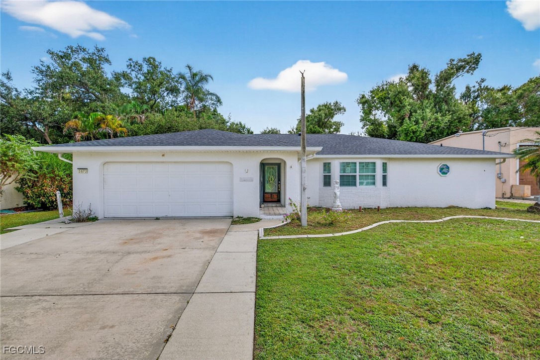 1672 Many Road North Fort Myers, FL 33903 - Photo 3 of 50 a view of a house with a yard and a garden