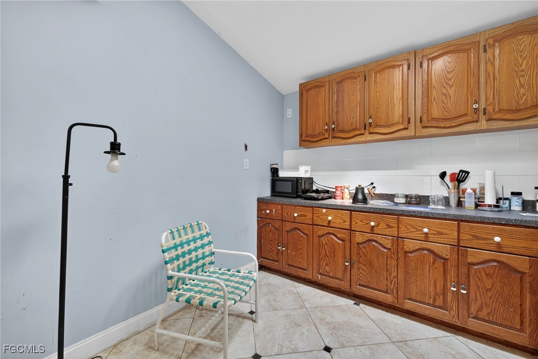 1672 Many Road North Fort Myers, FL 33903 - Photo 31 of 50 a kitchen with stainless steel appliances granite countertop a sink and cabinets