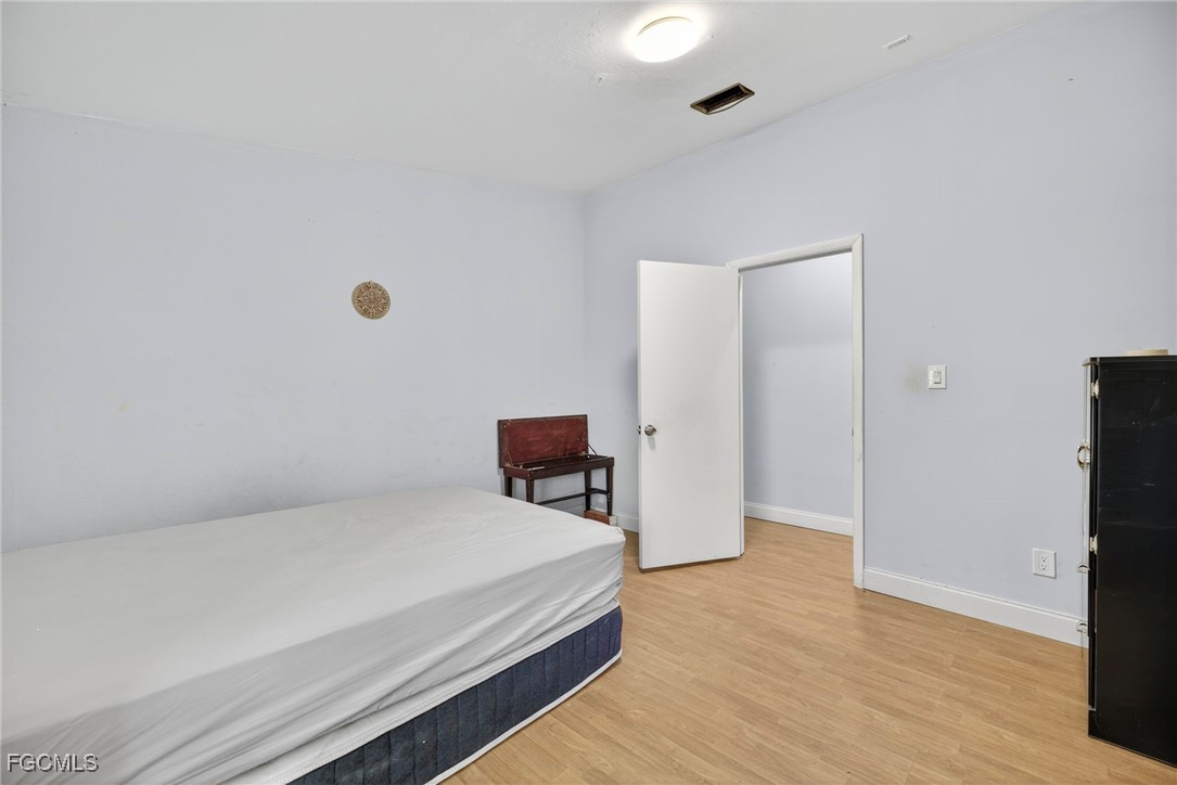 1672 Many Road North Fort Myers, FL 33903 - Photo 32 of 50 a room with a bed and furniture