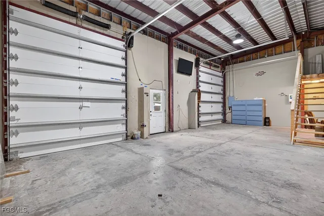 a view of an empty room with stairs and a furniture
