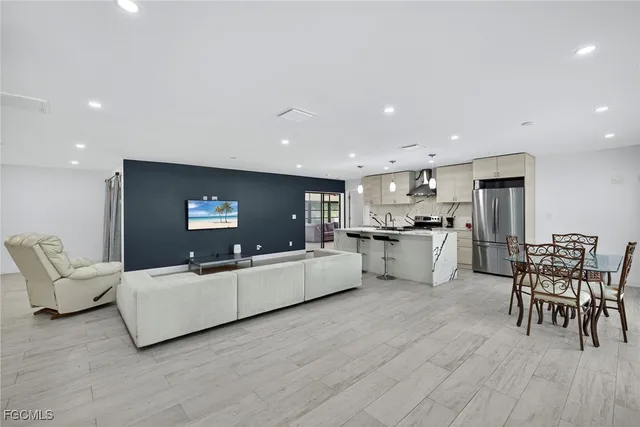 a living room with furniture and kitchen view