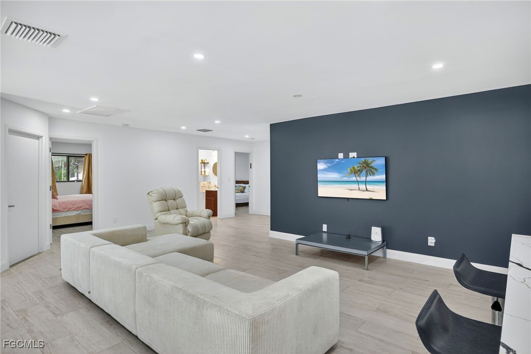 1672 Many Road North Fort Myers, FL 33903 - Photo 8 of 50 a living room with furniture and a flat screen tv