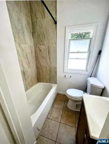 a bathroom with a bathtub and toilet