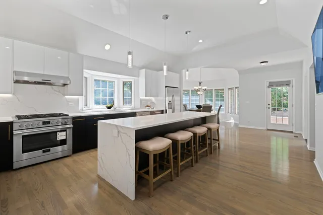 a kitchen with a stove and a wooden floor