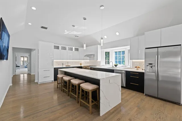 a kitchen with stainless steel appliances granite countertop a stove and a refrigerator