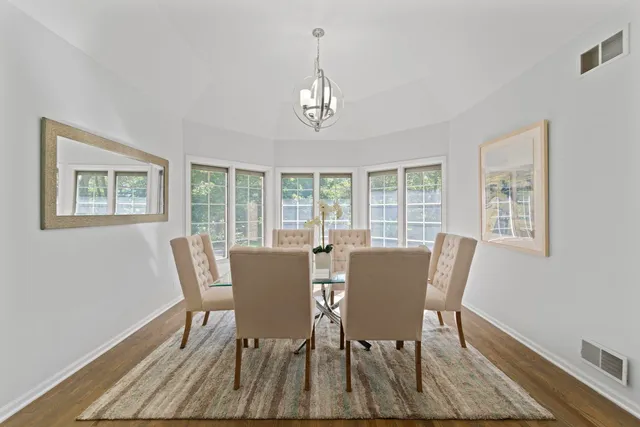 a view of a dining room with furniture wooden floor and a window