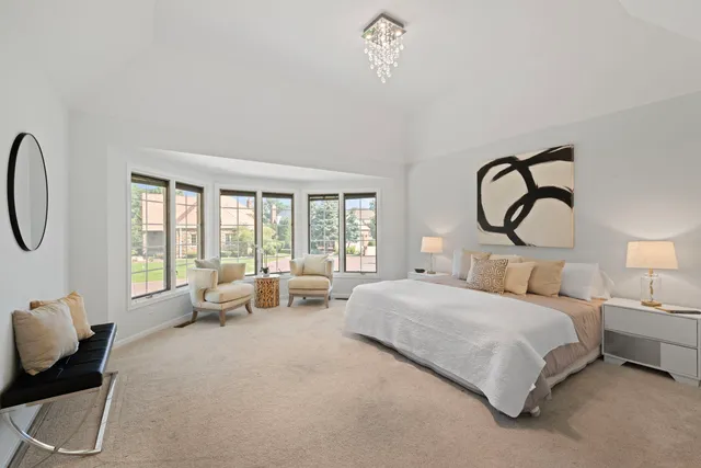 a bedroom with bed and a large window