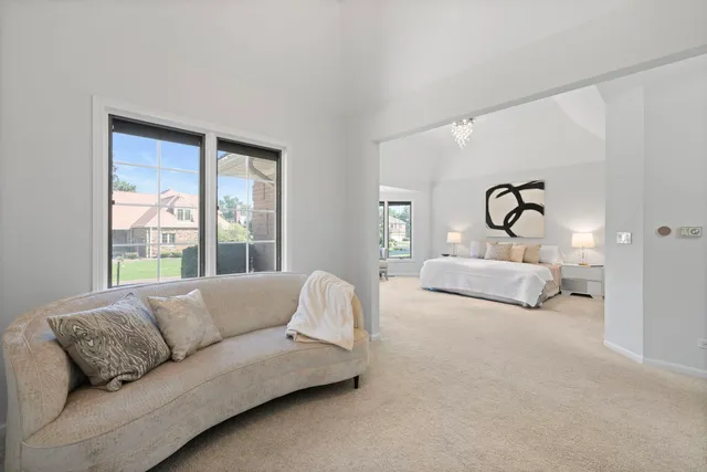a living room with couches and a large window with outer view