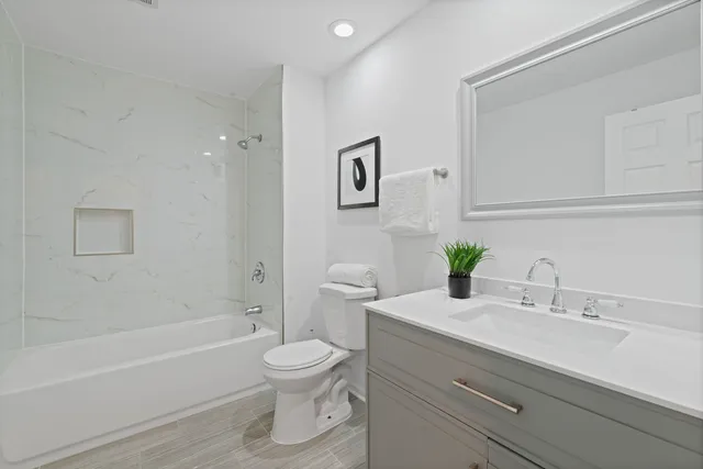 a bathroom with a sink toilet and bathtub