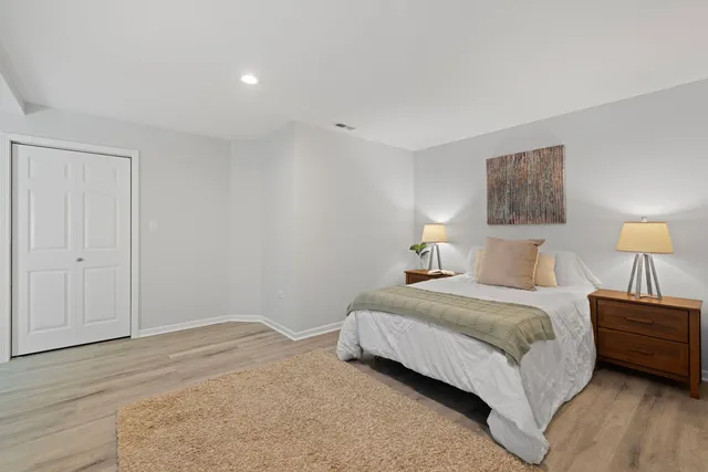 a bedroom with a bed and a lamp